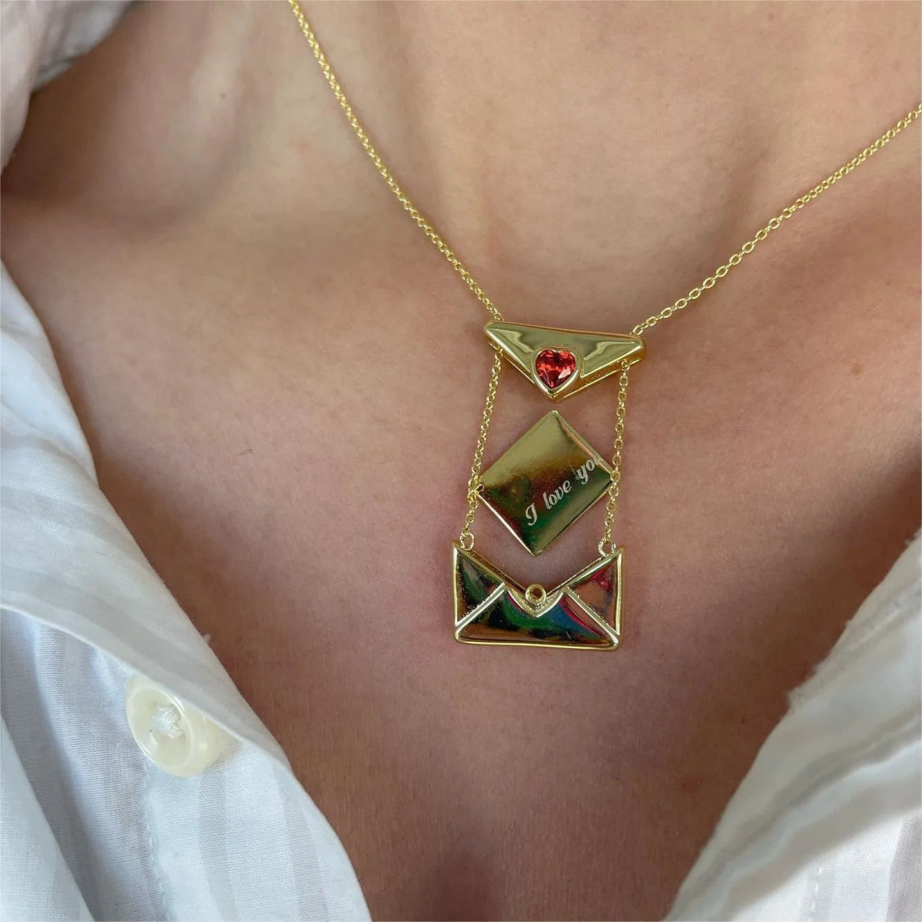 A copper envelope necklace inlaid with red hearts